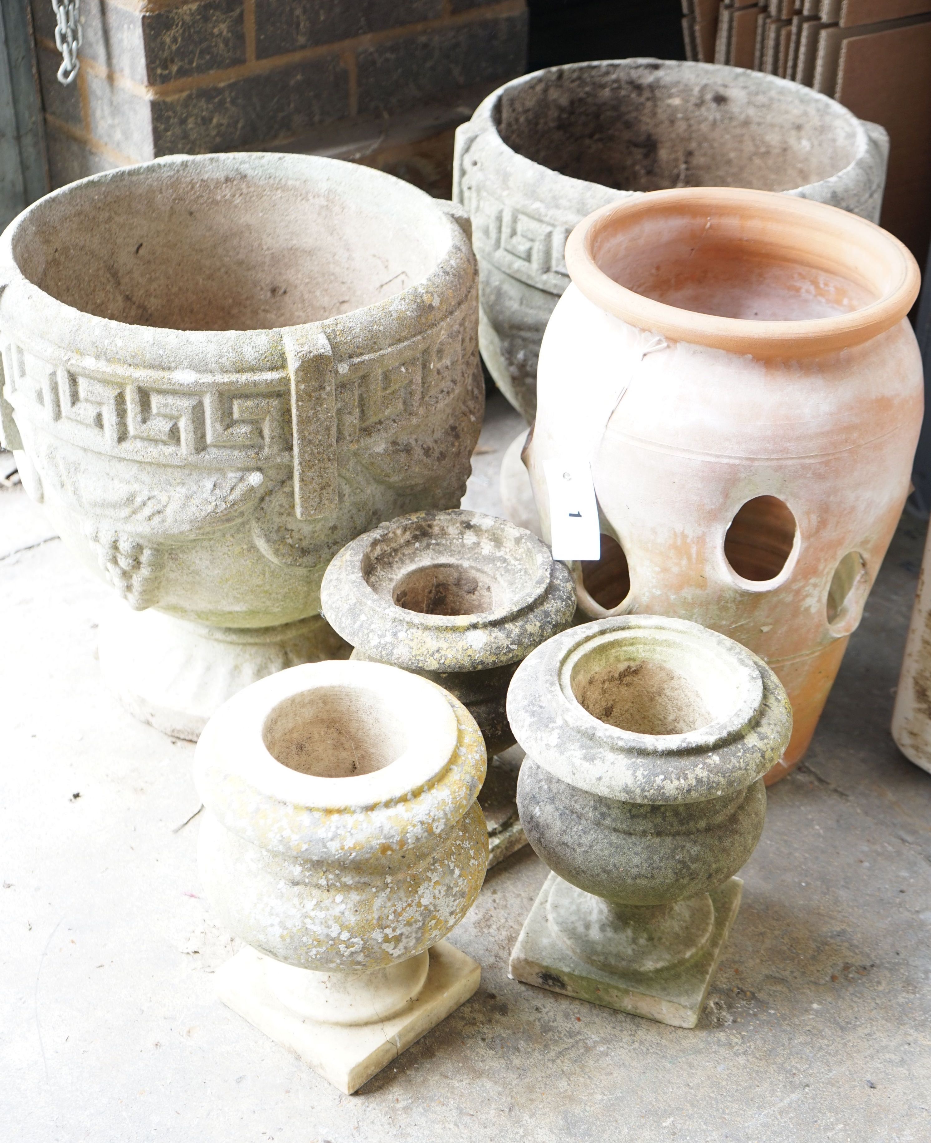 A pair of circular reconstituted stone garden urns, diameter 36cm, a terracotta strawberry pot and three other urns